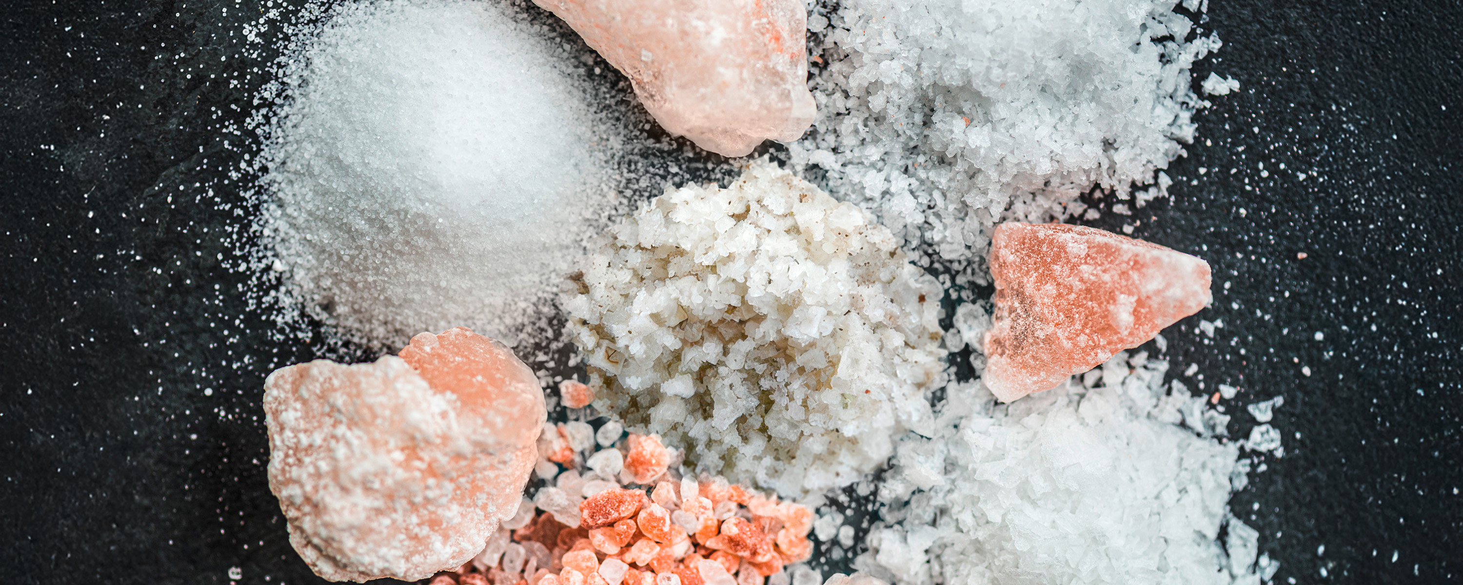 Different types of salt on a slate board